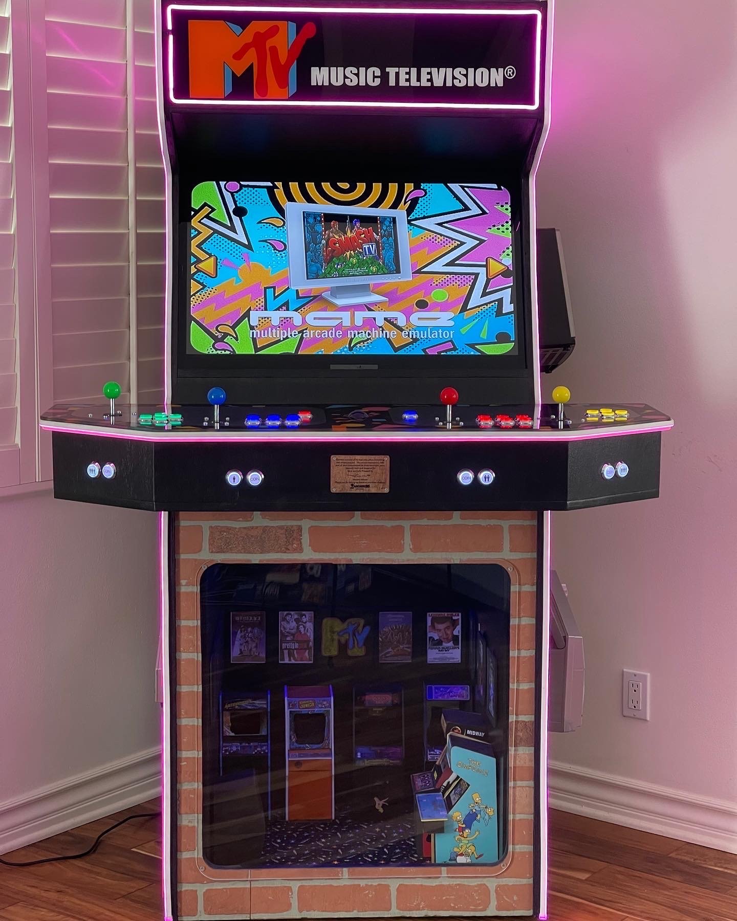 Full-size upright arcade cabinet with cyan LED trim and retro marquee
